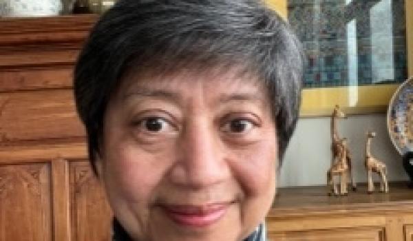 A portrait photo of Aye Aye Thwin a woman with short grayish hair smiling